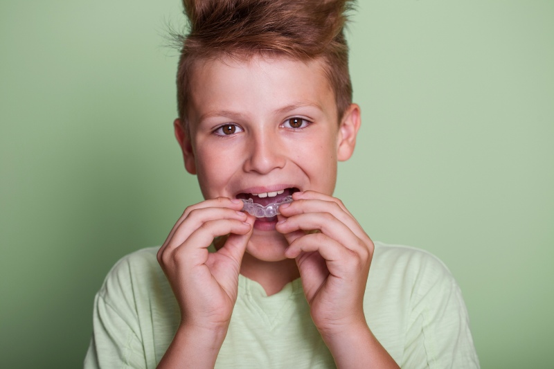 Boy trying a custom mouth guard designed specially for children in Pflugerville, TX