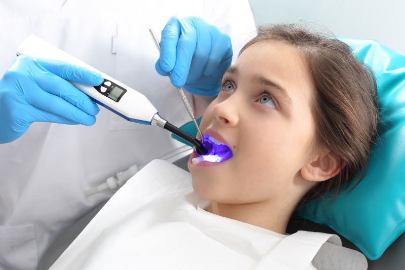 A girl getting dental sealants to protect teeth from dental cavities in Pflugerville, TX